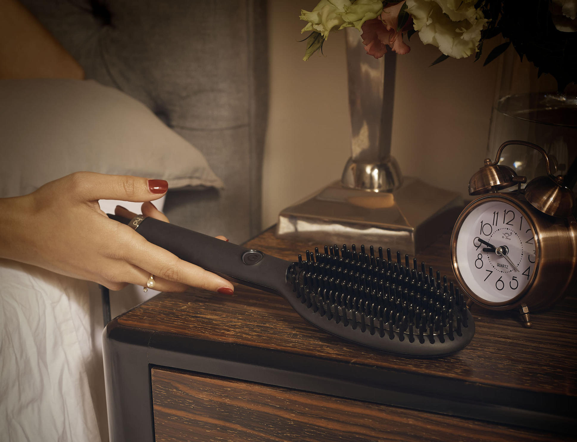 ghd hot brush on a bedside table