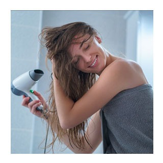 Woman blow-drying her hair